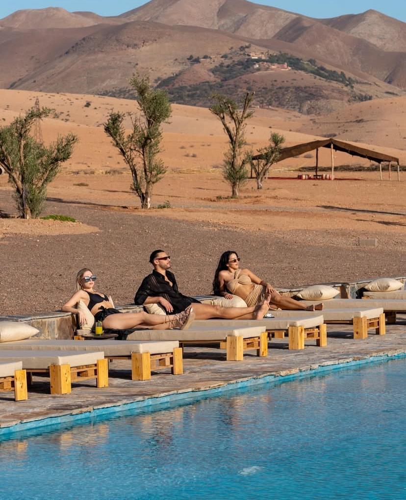 Pool day loungers beside a desert pool in Agafay